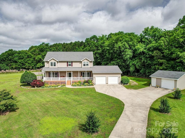 4111 Jenkins Rd, Marshville, NC 28103 - view of front of house with a porch, a front yard, driveway, a garage, and an outdoor structure