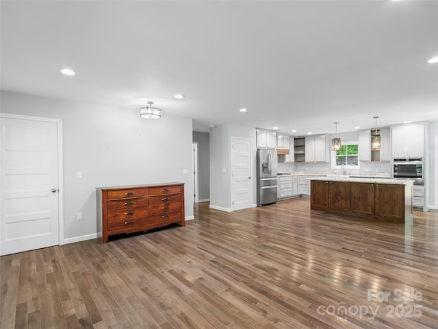 155 Pebble Ridge Rd, Spruce Pine, NC 28777 - unfurnished living room with dark wood-style floors, baseboards, recessed lighting, and a sink