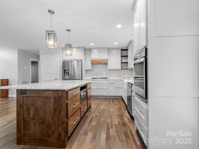 155 Pebble Ridge Rd, Spruce Pine, NC 28777 - kitchen with stainless steel appliances, wood finished floors, open shelves, a center island, and decorative light fixtures