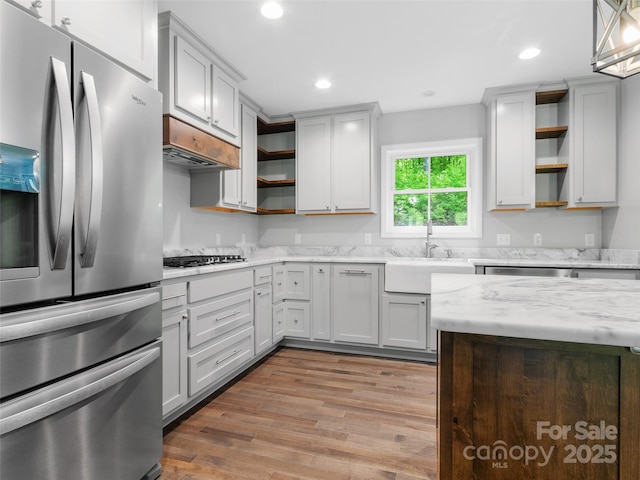 155 Pebble Ridge Rd, Spruce Pine, NC 28777 - kitchen with appliances with stainless steel finishes, open shelves, light wood-type flooring, a sink, and recessed lighting