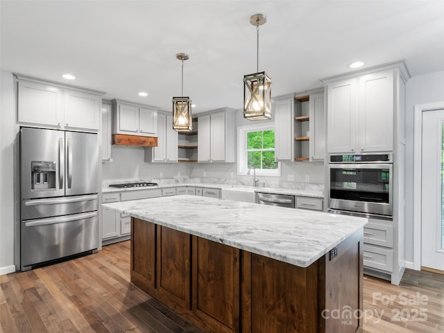 155 Pebble Ridge Rd, Spruce Pine, NC 28777 - kitchen with open shelves, appliances with stainless steel finishes, a sink, light wood-style floors, and a center island