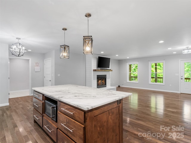 155 Pebble Ridge Rd, Spruce Pine, NC 28777 - kitchen with baseboards, recessed lighting, a brick fireplace, dark wood-style flooring, and hanging light fixtures