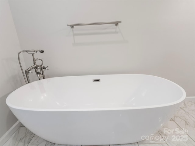 155 Pebble Ridge Rd, Spruce Pine, NC 28777 - bathroom featuring marble look tiles, a freestanding tub, and baseboards