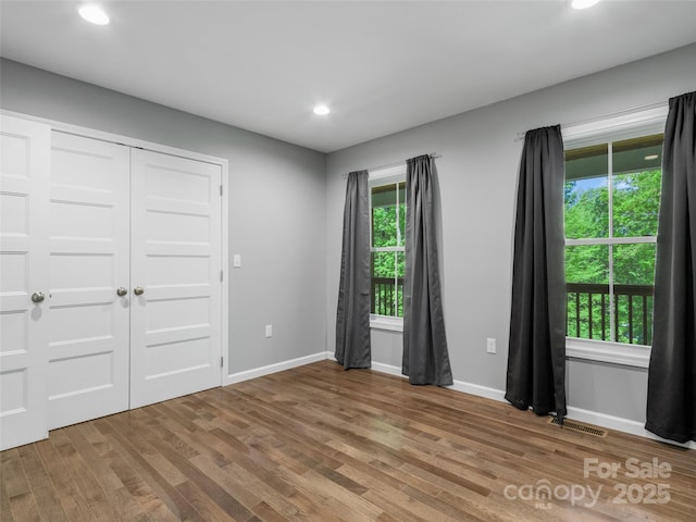 155 Pebble Ridge Rd, Spruce Pine, NC 28777 - unfurnished bedroom with wood finished floors, recessed lighting, baseboards, and a closet