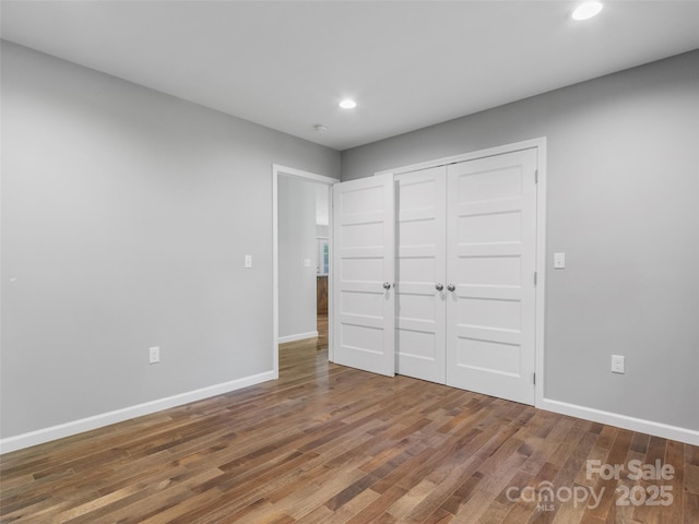 155 Pebble Ridge Rd, Spruce Pine, NC 28777 - unfurnished bedroom featuring recessed lighting, baseboards, wood finished floors, and a closet