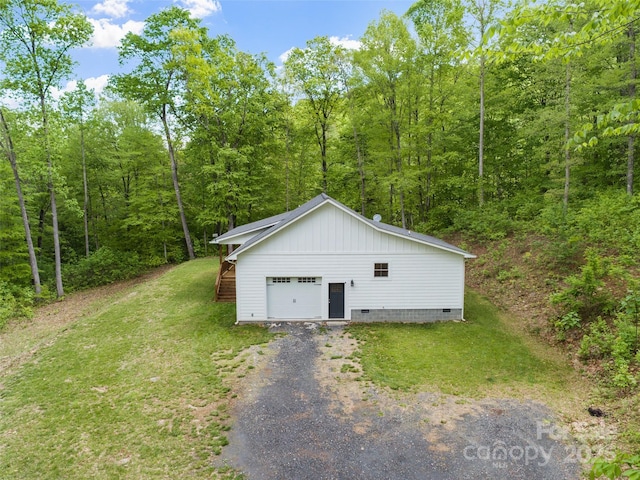 155 Pebble Ridge Rd, Spruce Pine, NC 28777 - garage featuring a view of trees and gravel driveway