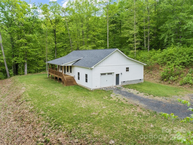 155 Pebble Ridge Rd, Spruce Pine, NC 28777 - view of front of home with roof with shingles, a front lawn, gravel driveway, and a wooded view