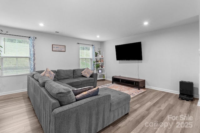 living room featuring recessed lighting, wood finished floors, and baseboards