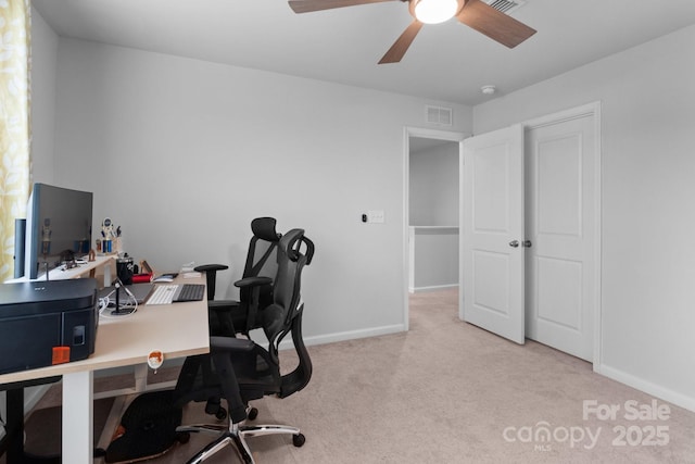 carpeted office featuring ceiling fan and baseboards