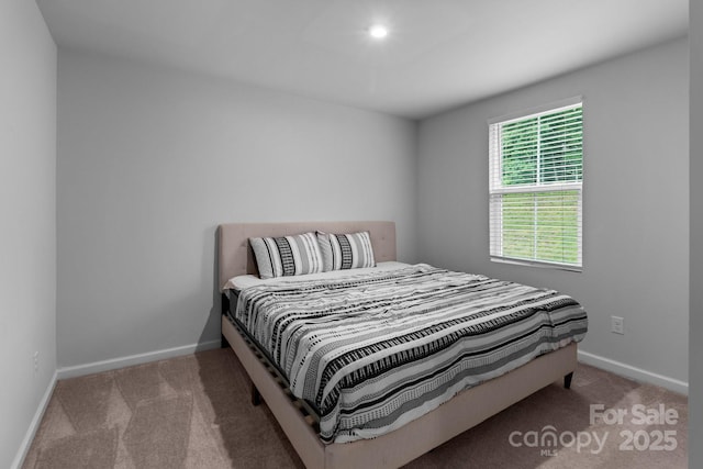 bedroom featuring carpet flooring and baseboards