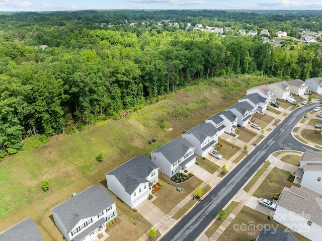 aerial view of residential area with a heavily wooded area