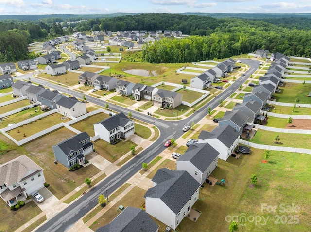 aerial perspective of suburban area featuring a heavily wooded area