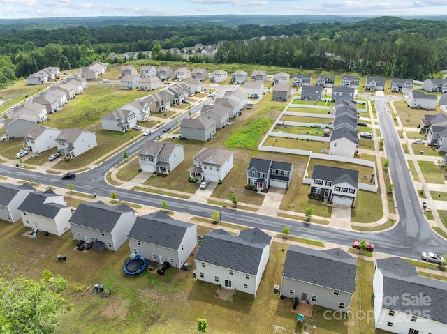 aerial view of residential area featuring a heavily wooded area