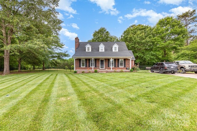 3049 Stablegate Dr, Gastonia, NC 28052 - cape cod home with a chimney, brick siding, and covered porch