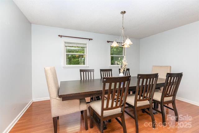 3049 Stablegate Dr, Gastonia, NC 28052 - dining room featuring light wood-style floors, a chandelier, and baseboards