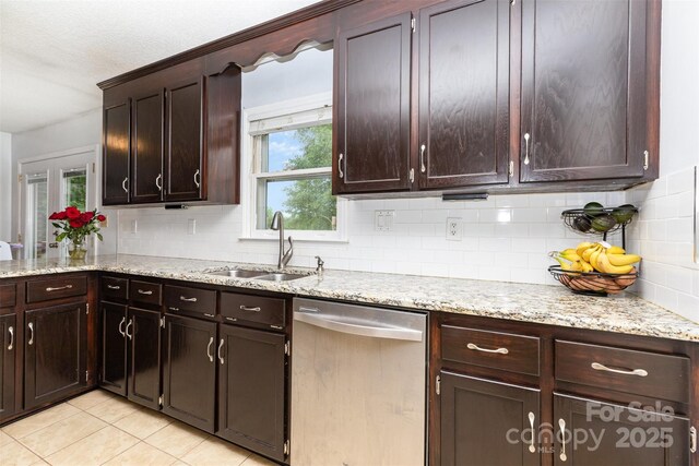 3049 Stablegate Dr, Gastonia, NC 28052 - kitchen with stainless steel dishwasher, a sink, backsplash, and light tile patterned floors