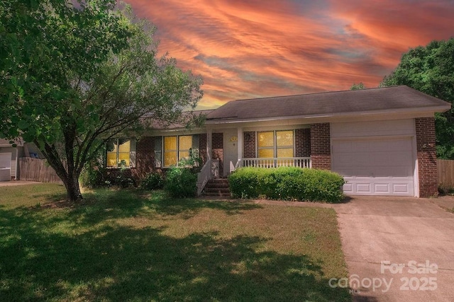 305 Ridge Manor Dr, Raeford Township, NC 28376 - ranch-style home with brick siding, a garage, concrete driveway, and a porch