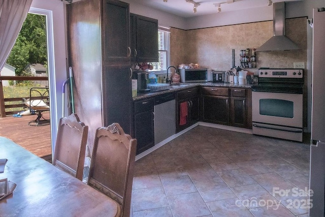 305 Ridge Manor Dr, Raeford Township, NC 28376 - kitchen featuring stainless steel appliances, wall chimney exhaust hood, a sink, and dark cabinets