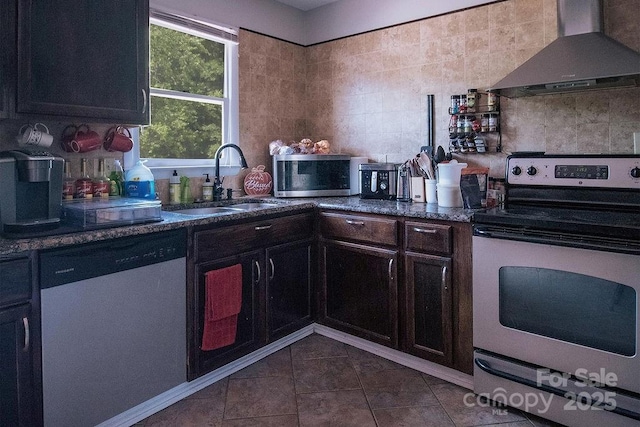 305 Ridge Manor Dr, Raeford Township, NC 28376 - kitchen featuring wall chimney exhaust hood, stainless steel appliances, a sink, backsplash, and dark tile patterned floors