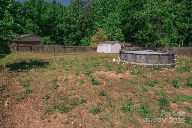 305 Ridge Manor Dr, Raeford Township, NC 28376 - fenced backyard featuring a storage shed and an outbuilding