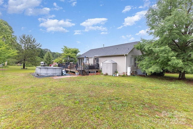 2906 Chapman Cir, Rock Hill, SC 29732 - rear view of house featuring a storage unit, a wooden deck, an outbuilding, an outdoor pool, and a lawn