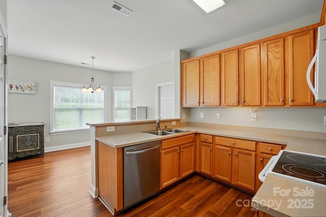 kitchen featuring stainless steel dishwasher, a sink, dark wood-style flooring, and a peninsula