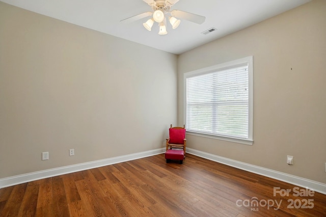 unfurnished room featuring baseboards, wood finished floors, and ceiling fan