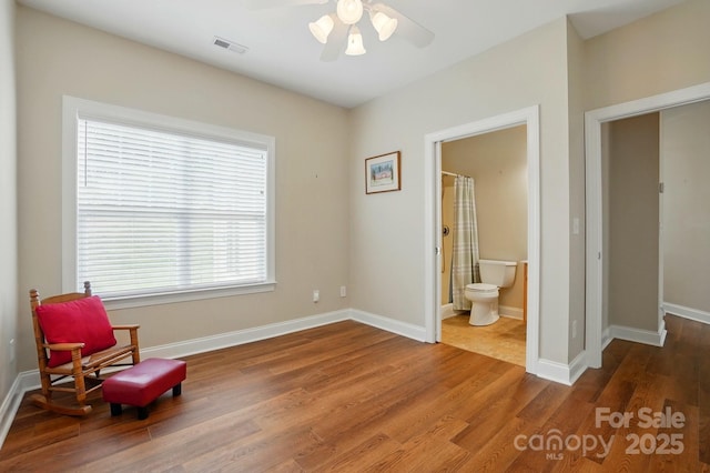 sitting room featuring ceiling fan, wood finished floors, and baseboards