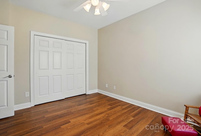 unfurnished bedroom with baseboards, wood finished floors, and ceiling fan