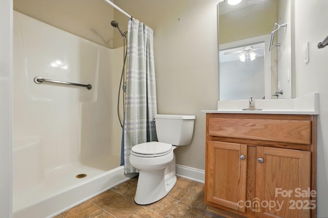 full bathroom with toilet, a shower with shower curtain, baseboards, vanity, and tile patterned flooring