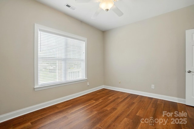 unfurnished room featuring ceiling fan, wood finished floors, and baseboards