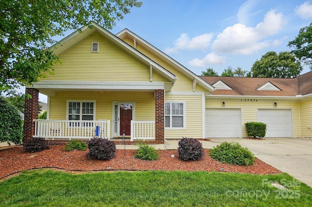 view of front of home with an attached garage, a porch, and concrete driveway