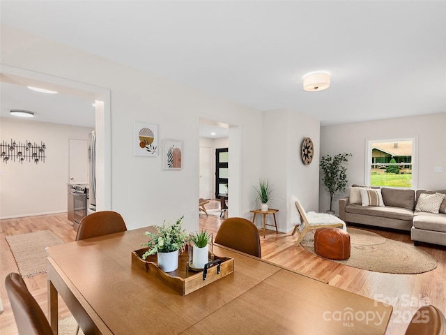 16 Emerson Poore Dr, Candler, NC 28715 - dining space featuring light wood-type flooring and baseboards