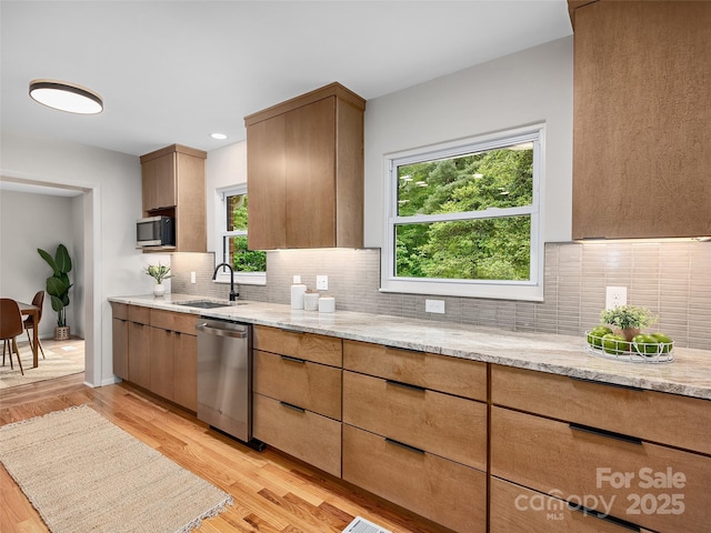16 Emerson Poore Dr, Candler, NC 28715 - kitchen with a sink, stainless steel appliances, light stone countertops, and light wood-style flooring