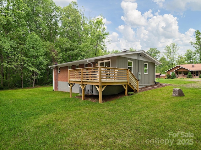16 Emerson Poore Dr, Candler, NC 28715 - back of house featuring a deck, a yard, and board and batten siding