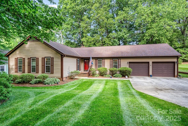 single story home featuring concrete driveway, a garage, a front lawn, and roof with shingles