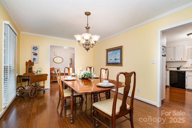 dining space featuring a chandelier, ornamental molding, dark wood-style flooring, baseboards, and a textured ceiling
