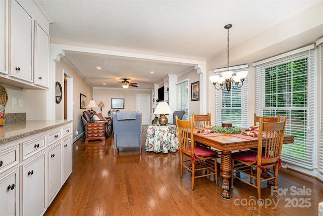 dining room featuring crown molding, a chandelier, wood finished floors, a ceiling fan, and recessed lighting