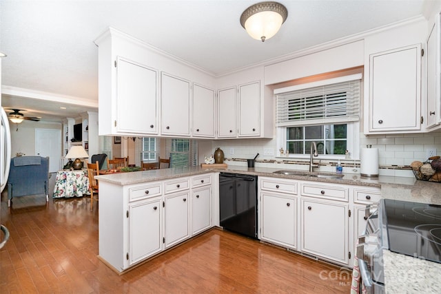 kitchen featuring dishwasher, a sink, crown molding, a peninsula, and tasteful backsplash