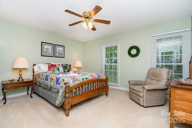 carpeted bedroom with baseboards and ceiling fan