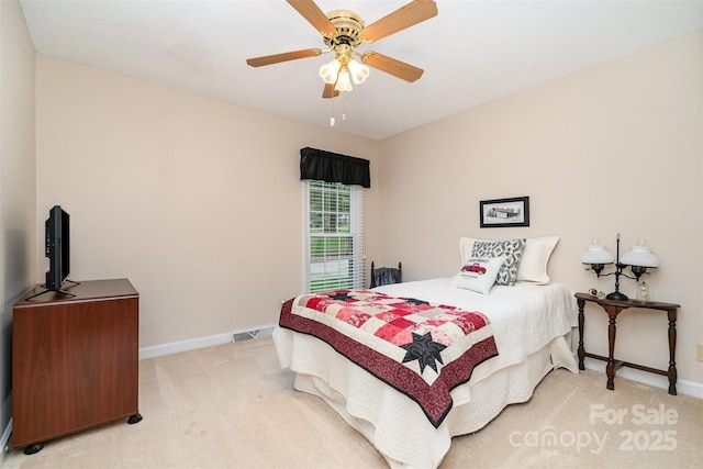 bedroom featuring light colored carpet, baseboards, and ceiling fan