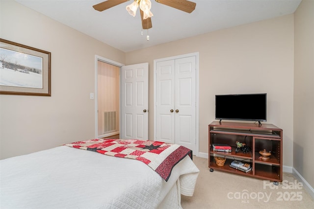 carpeted bedroom with baseboards, a closet, and a ceiling fan