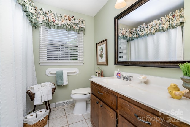 full bath featuring toilet, vanity, tile patterned flooring, and baseboards