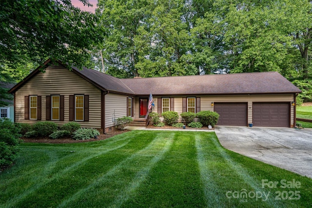 single story home featuring an attached garage, concrete driveway, a front yard, and roof with shingles