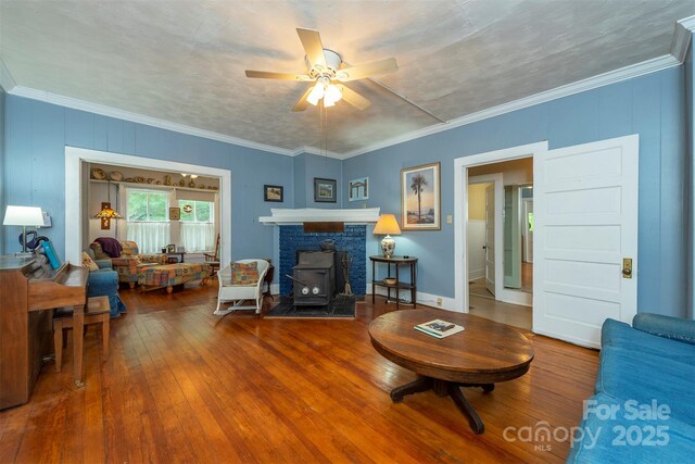 223 Assembly Dr, Montreat, NC 28757 - living area with a ceiling fan, hardwood / wood-style floors, a wood stove, and crown molding