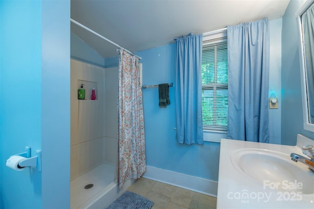 223 Assembly Dr, Montreat, NC 28757 - bathroom featuring a stall shower, tile patterned flooring, vanity, vaulted ceiling, and baseboards