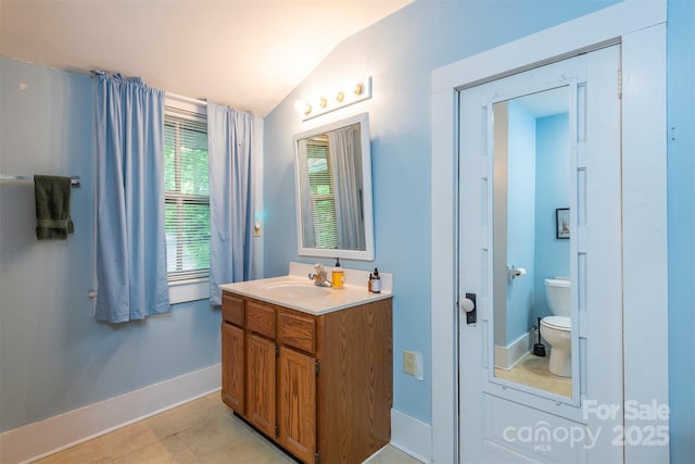 223 Assembly Dr, Montreat, NC 28757 - bathroom with vaulted ceiling, toilet, baseboards, vanity, and tile patterned flooring