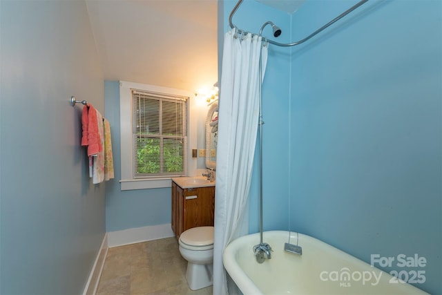 223 Assembly Dr, Montreat, NC 28757 - bathroom featuring a soaking tub, vanity, baseboards, and toilet