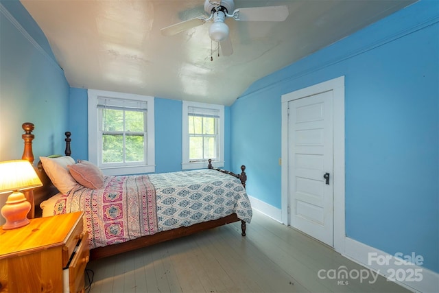223 Assembly Dr, Montreat, NC 28757 - bedroom with wood finished floors, vaulted ceiling, baseboards, and ceiling fan