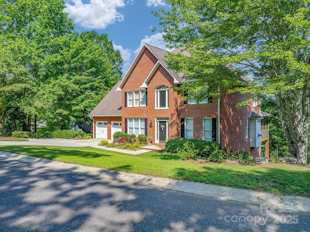 357 Lentz Landing Ln, Nebo, NC 28761 - colonial home with concrete driveway, a garage, brick siding, and a front yard